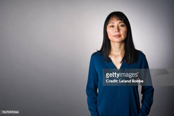 studio portrait of adult japanese woman with long dark hair - mature women portrait asian bildbanksfoton och bilder