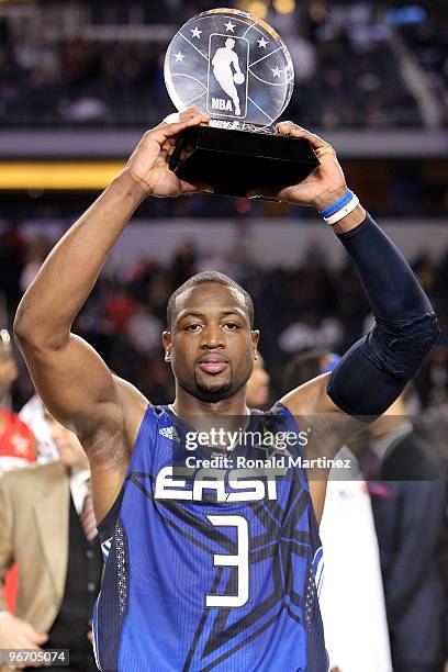 Dwyane Wade of the Eastern Conference celebrates with the trophy after being named the MVP of the NBA All-Star Game, part of 2010 NBA All-Star...