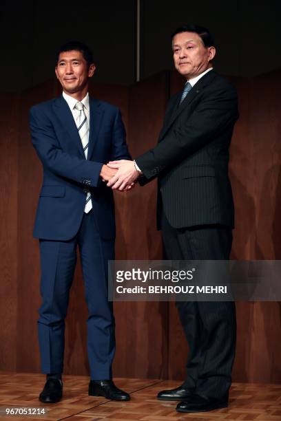 Toshiba Memory Corp. President Yasuo Naruke and head of Bain Capital's operations in Japan, Yuji Sugimoto , shake hands after a joint press...