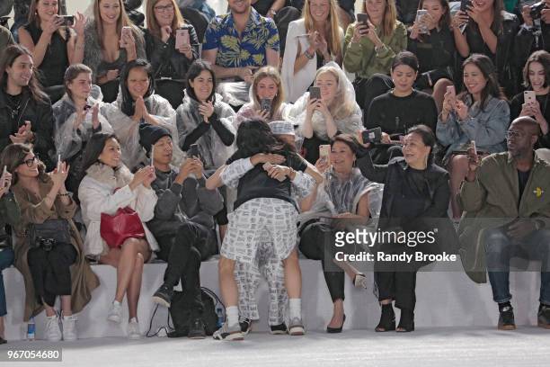 Designer Alexander Wang hugs an audience member after his Alexander Wang Resort Runway show June 2018 New York Fashion Week on June 3, 2018 in New...