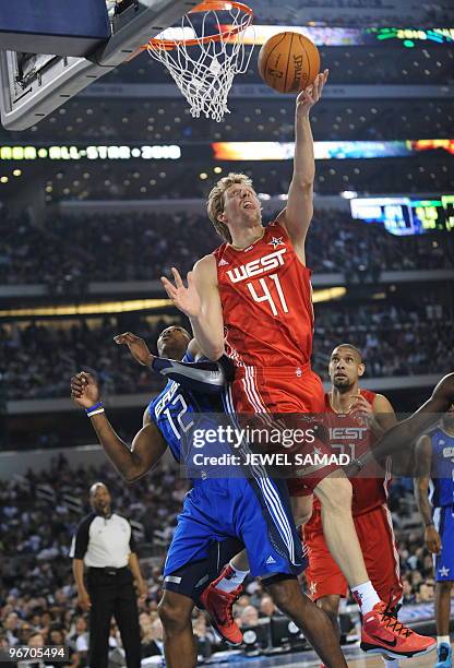 Dirk Nowitzki of the Western Conference shoots against Dwight Howard of the Eastern Conference during the third quarter of the NBA All-Star Game,...