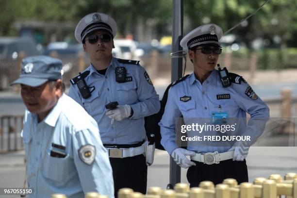 Police officers stand guard near Tiananmen Square on the anniversary of the 1989 crackdown on democracy protestors, in Beijing on June 4, 2018. -...