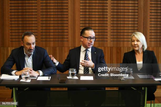 Alan Joyce, chief executive officer of Qantas Airways Ltd., center, speaks, as Gareth Evans, chief executive officer of Jetstar Group, left, and...