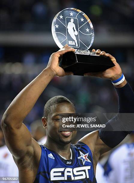 Dwyane Wade of the Eastern Conference celebrates with the trophy after being named the MVP of the NBA All-Star Game, part of 2010 NBA All-Star...