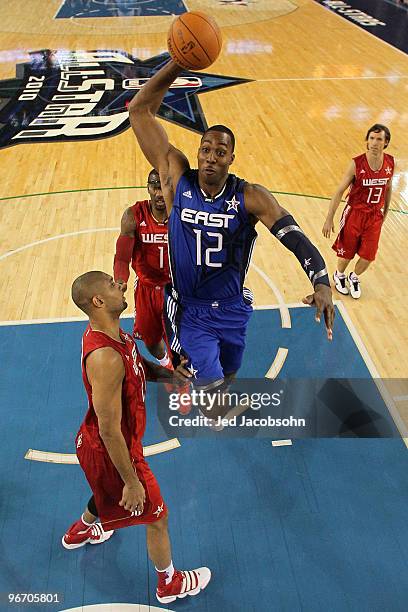 Dwight Howard of the Eastern Conference goes up for a dunk against Tim Duncan, Amar'e Stoudemire and Steve Nash of the Western Conference during the...