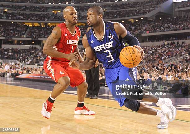 Dwyane Wade of the Eastern Conference drives against Chauncey Billups of the Western Conference during the NBA All-Star Game as part of the 2010 NBA...