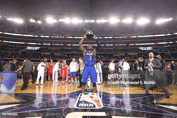 Dwyane Wade of the Eastern Conference hoists his MVP trophy after a win against the Western Conference during the NBA All-Star Game as part of the...