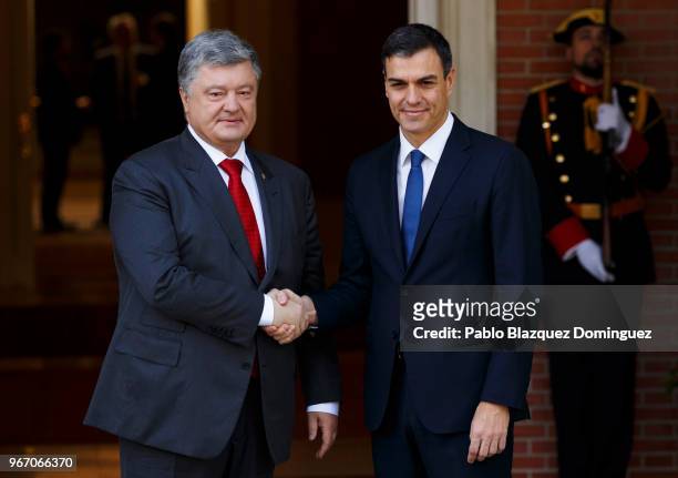 Spain's new Prime Minister Pedro Sanchez shakes hands with the President of Ukraine Petro Poroshenko as they pose for the press at Moncloa Palace on...