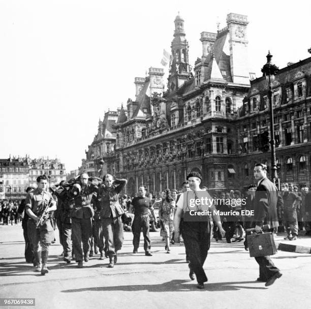 S leading German prisoners on the Place de l'Hotel de Ville on August 25 after the Hotel de Ville was besieged. The man with the armband, seen from...