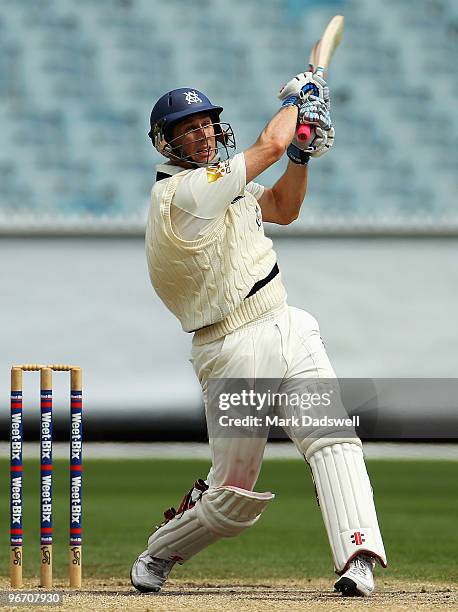 David Hussey of the Bushrangers smashes a short ball down the ground during day four of the Sheffield Shield match between the Victorian Bushrangers...