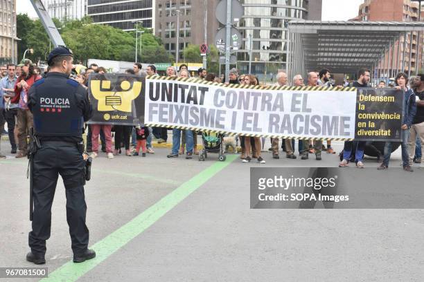 Policeman seen looking at the protesters during the demonstration. Hundred UCFR supporters manifested in Barcelona against the political act of the...