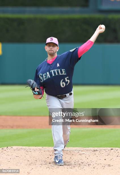 James Paxton of the Seattle Mariners throws a warm-up pitch while wearing a pink hat and shirt to honor Mother's Day during the game against the...