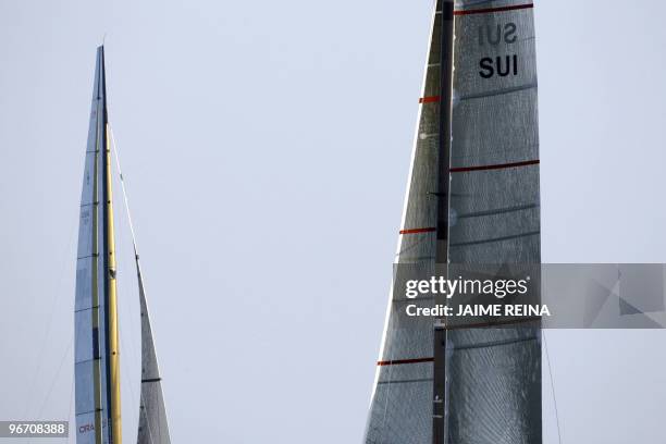 Swiss defender Alinghi huge catamaran and US challenger Oracle giant trimaran wait for the start of the opening race of the 33rd America's Cup off...