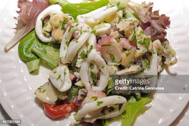 seafood salad with italian bread on the side served on christmas eve as part of the feast of the seven fishes. - side salad stock pictures, royalty-free photos & images