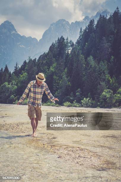 senior man in alps - barefoot snow stock pictures, royalty-free photos & images