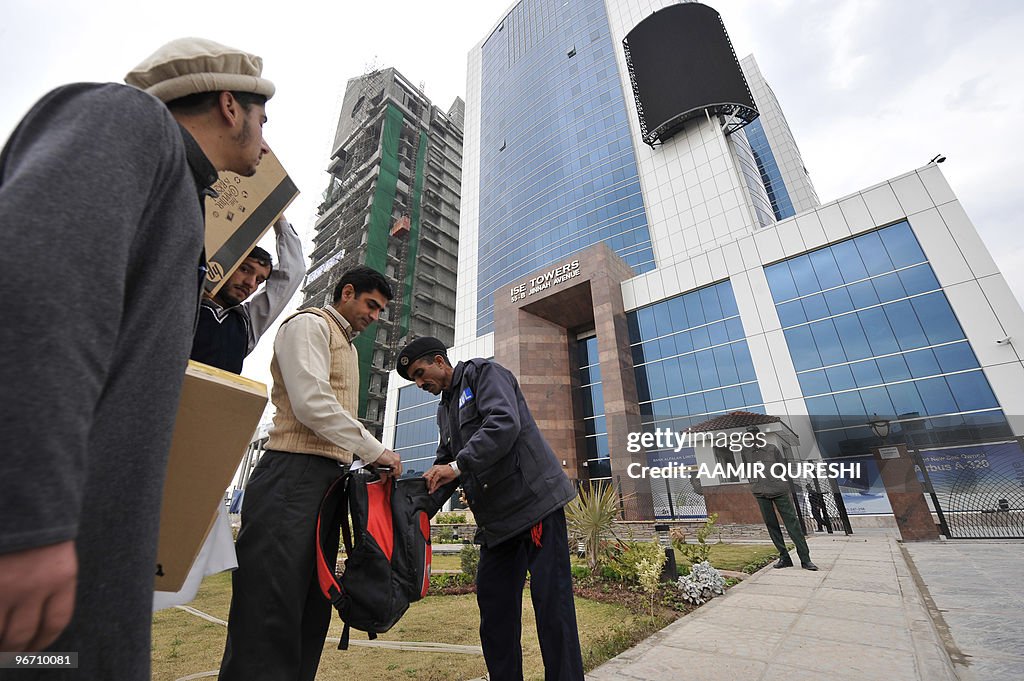 A Pakistani security guard searches a ma