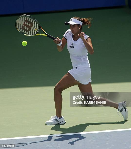 India's Sania Mirza returns the ball to Spain's Anabel Medina Garrigues during their WTA Dubai Tennis Championships first round match in the Gulf...