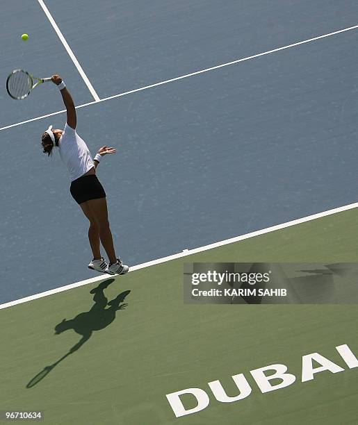 Spain's Anabel Medina Garrigues serves to India's Sania Mirza during their WTA Dubai Tennis Championships first round match in the Gulf emirate on...