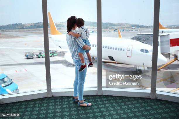 mother and son with airplane on background - baby gate imagens e fotografias de stock