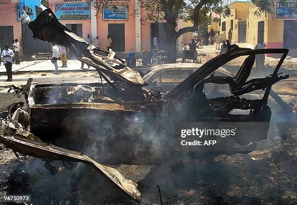 Somalis mill around the scene of a car-bomb attack at Mogadishu�s Maka Al-Mukarama road on February 15, 2010. Somali State Minister of Defence, Yusuf...