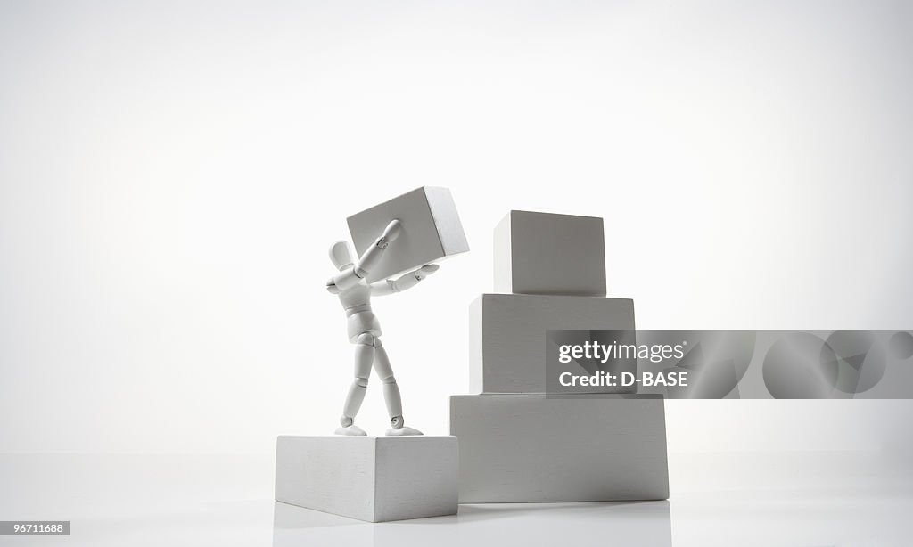 White figure carrying a box to the top