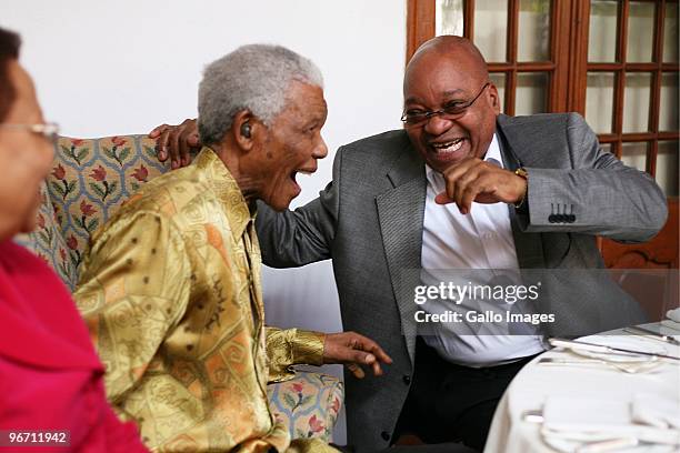 President Jacob Zuma laughs with former South African president Nelson Mandela during a luncheon for men from the Rivonia trials and political...