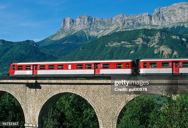 train crossing over a viaduct in the mountains - high speed train stock pictures, royalty-free photos & images