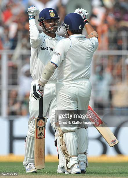 Virender Sehwag of India celebrates his 100 with Sachin Tendulkar during day two of the Second Test match between India and South Africa at Eden...