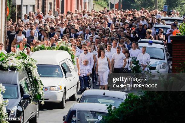 People attend on June 4, 2018 in Vottem near Liege, the funeral procession for Cyril Vangriecken, one of the three victims of a shooting the week...