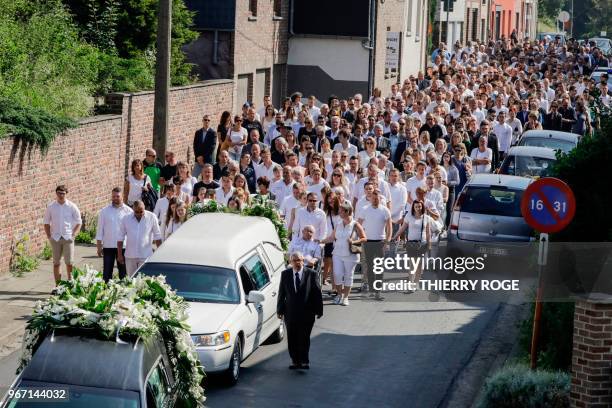 People attend on June 4, 2018 in Vottem near Liege, the funeral procession for Cyril Vangriecken, one of the three victims of a shooting the week...