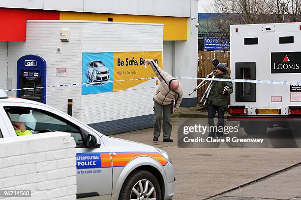 Police attend the scene of an unconfirmed armed robbery involving a Loomis security van and the ATM machine at a Shell garage, Yiewsley on February...