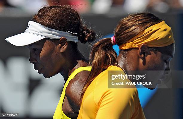 Serena Williams of the US walks past partner Venus Williams of the US as they play Cara Black of Zimbabwe and Liezel Huber of the US in the women's...