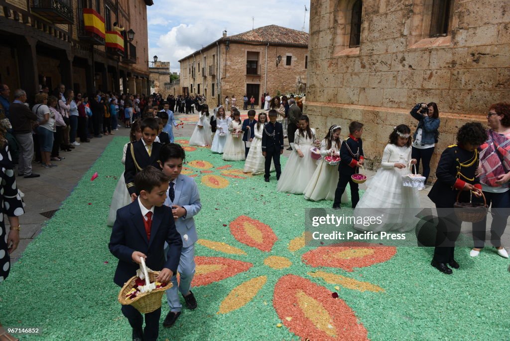 Boys and girls wearing white dress from the communion stand...