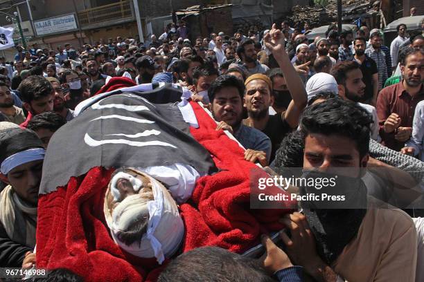 People carry the body of 23 yr old orphan and lone brother of two sisters Qaiser Amin Bhat who succumbed to his injuries after Indian paramilitary...