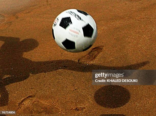 An Angolan boy plays football on the Atlantic ocean beach in Benguela on January 29, 2010 during the African Nations Cup football tournament which...