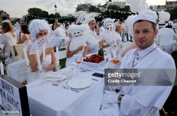 People dressed in white gather for the 30th edition of the 'Diner En Blanc' event on the Invalides esplanade on June 3, 2018 in Paris, France. The...