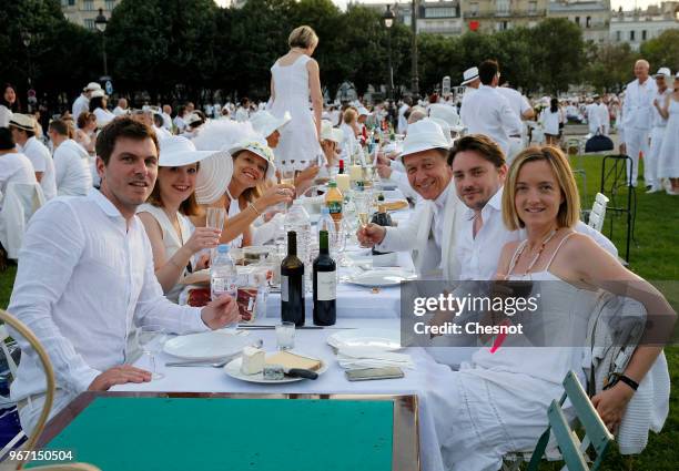 People dressed in white gather for the 30th edition of the 'Diner En Blanc' event on the Invalides esplanade on June 3, 2018 in Paris, France. The...