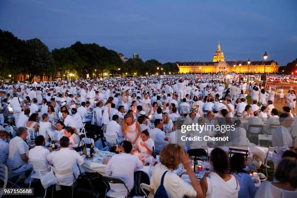 People dressed in white gather for the 30th edition of the 'Diner En Blanc' event on the Invalides esplanade on June 3, 2018 in Paris, France. The...