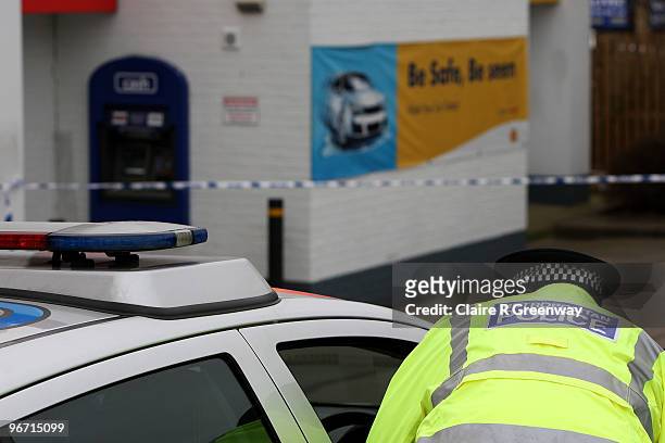 Police attend the scene of an unconfirmed armed robbery involving a Loomis security van and the ATM machine at a Shell petrol station in Yiewsley on...