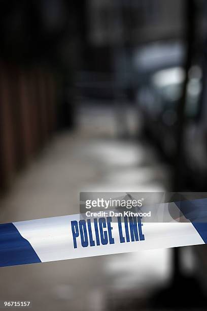 Police tape marks off an area where a man was stabbed and killed in South Norwood on February 15, 2010 in London, United Kingdom. As the UK gears up...