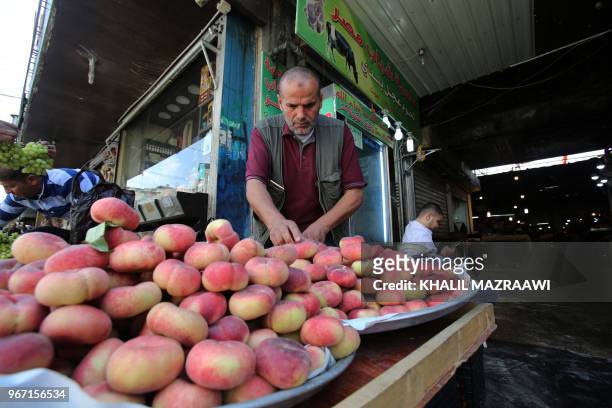 Vendors sell fruits in downtown Amman on June 4 , 2018. Jordan's King Abdullah has summoned the prime minister for a meeting that could pave the way...