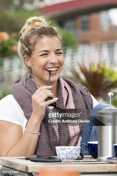 Gemma Atkinson smiles as she joins Gethin Jones and Dave Vitty from The Hits Radio as they celebrate the airing of their first show on June 4, 2018...