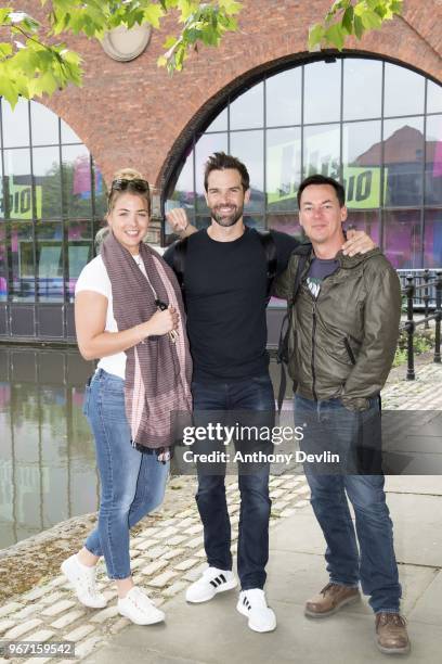 Gemma Atkinson, Gethin Jones and Dave Vitty from The Hits Radio pose together as they celebrate the airing of their first show on June 4, 2018 in...