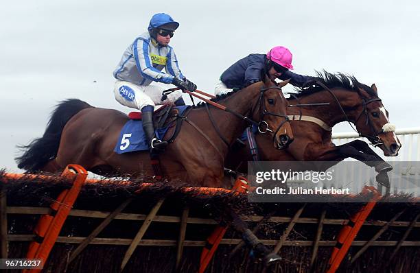 Timmy Murphy and Preuty Boy clear the last flight in company with the Liam Treadwell ridden Ballybach before going on and win The totesuper7 Handicap...