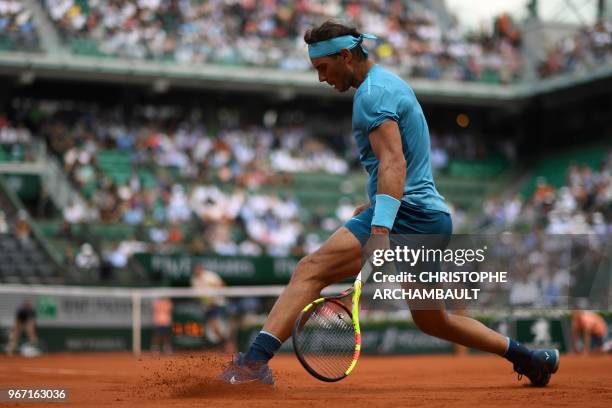 Spain's Rafael Nadal slides after playing a return to Germany's Maximilian Marterer during their men's singles fourth round match on day nine of The...