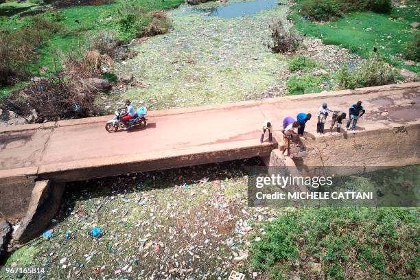 General view shows a section of the Niger river in Bamako clogged with plastic waste and other polluting materials on June 2, 2018. - The United...