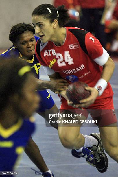 Ines Khouildi of Tunis challenged by Musonda Kasangala Lydia of Congo during their quarter-final match in 19th Africa Nations Handball Championship...