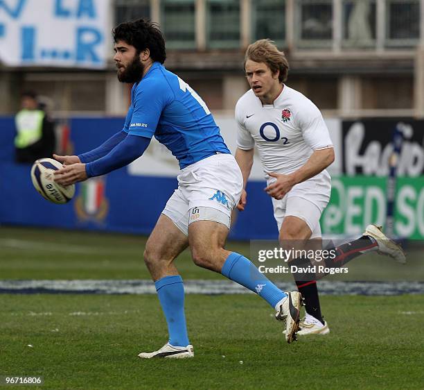 Luke McLean of Italy passes the ball watched by Mathew Tait during the RBS Six Nations match between Italy and England at Stadio Flaminio on February...