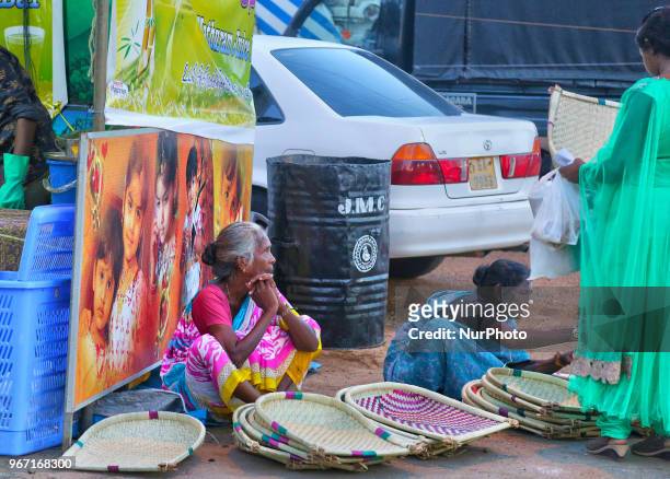 Tamil women sell items as crowds of people throng to the shops surrounding the Nallur Kandaswamy Kovil during the festival season in Jaffna, Sri...