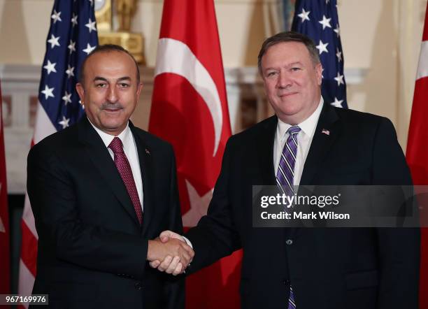 Secretary of State Mike Pompeo , greets Turkish Foreign Minister Mevlut Cavusoglu, before a meeting at the Department of State on June 4, 2018 in...